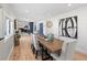 Bright dining room with a long wooden table that flows into the modern kitchen at 6111 W Fremont Dr, Littleton, CO 80128