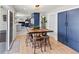 Dining area leading into the kitchen, featuring a wood table with views of the backyard at 6111 W Fremont Dr, Littleton, CO 80128
