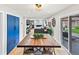 Dining area featuring a rustic wooden table, views of the backyard, and access to the living room at 6111 W Fremont Dr, Littleton, CO 80128