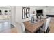 Dining room featuring a long wooden table and white chairs in an open-concept space at 6111 W Fremont Dr, Littleton, CO 80128