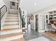 Bright entryway with stylish staircase, modern fixtures, and a glimpse of the home's open layout at 6111 W Fremont Dr, Littleton, CO 80128