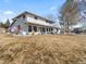 Two-story white home with a spacious yard and inviting front porch seating area at 6111 W Fremont Dr, Littleton, CO 80128