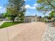 Charming home showcasing a well-manicured lawn and a long driveway leading to an attached two-car garage at 6111 W Fremont Dr, Littleton, CO 80128