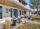 Welcoming front porch with cozy seating and double blue doors, great curb appeal at 6111 W Fremont Dr, Littleton, CO 80128