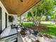 Inviting front porch with comfortable seating, plants, and views of the well-maintained yard at 6111 W Fremont Dr, Littleton, CO 80128