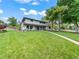 Lush front yard with a manicured lawn leading to the beautiful home with a blue front door at 6111 W Fremont Dr, Littleton, CO 80128