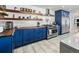 Bright kitchen with custom blue cabinets, butcher block counters, stainless steel appliances, and open wood shelving at 6111 W Fremont Dr, Littleton, CO 80128
