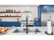 Kitchen featuring stainless steel appliances, butcher block counters, open shelving, and a modern sink and faucet at 6111 W Fremont Dr, Littleton, CO 80128