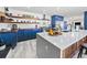 Modern kitchen featuring custom blue cabinets, butcher block countertops, and a large center island at 6111 W Fremont Dr, Littleton, CO 80128