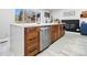 Kitchen island featuring a quartz countertop, wood cabinets, stainless steel dishwasher, and views of the backyard at 6111 W Fremont Dr, Littleton, CO 80128
