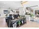 Open-concept living room with hardwood floors, modern staircase, and stylish decor at 6111 W Fremont Dr, Littleton, CO 80128