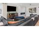Spacious living area with a modern fireplace, comfortable seating, and a large television at 6111 W Fremont Dr, Littleton, CO 80128