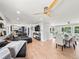 Open-concept living area featuring hardwood floors, a sectional sofa, and plenty of natural light at 6111 W Fremont Dr, Littleton, CO 80128