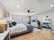 Spacious main bedroom with light hardwood floors, two windows, and neutral decor at 6111 W Fremont Dr, Littleton, CO 80128