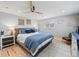 Bright main bedroom featuring a ceiling fan, hardwood floors, and comfortable furnishings at 6111 W Fremont Dr, Littleton, CO 80128