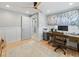 Bright office space features a wooden desk, comfortable chair, and large artwork for a productive work environment at 6111 W Fremont Dr, Littleton, CO 80128