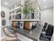 Home office featuring built-in shelves with a gray countertop, two chairs, and large windows at 6111 W Fremont Dr, Littleton, CO 80128