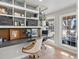 Home office featuring built-in shelves with floral wallpaper, a gray countertop, and views of the neighborhood at 6111 W Fremont Dr, Littleton, CO 80128