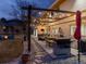 Backyard outdoor dining area with built-in grill, comfortable seating, and a pergola with string lights at 6111 W Fremont Dr, Littleton, CO 80128