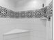 Close-up of the shower, highlighting its patterned tile accents and built-in bench at 6111 W Fremont Dr, Littleton, CO 80128