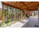 A covered deck provides an outdoor space to enjoy the backyard view at 9185 Jill Dr, Conifer, CO 80433