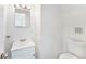 Compact bathroom features a modern sink, vanity, and toilet in a clean, minimalist design at 9185 Jill Dr, Conifer, CO 80433