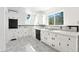 Well-lit kitchen boasts white cabinetry and ample counter space, perfect for culinary endeavors at 9185 Jill Dr, Conifer, CO 80433
