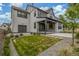 Spacious backyard with a well-kept lawn, gravel accents, concrete patio, and detached garage at 1846 Chestnut Ave, Erie, CO 80516