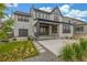 Stunning home exterior with a covered patio, manicured lawn, and modern architectural details at 1846 Chestnut Ave, Erie, CO 80516
