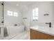 Bright bathroom featuring a freestanding tub, white marble countertops, and modern fixtures at 1846 Chestnut Ave, Erie, CO 80516