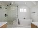 Bathroom with a soaking tub, walk-in shower, and modern fixtures at 1846 Chestnut Ave, Erie, CO 80516