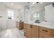 Bright bathroom featuring a double vanity, quartz countertop, and modern fixtures at 1846 Chestnut Ave, Erie, CO 80516