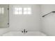Close-up of a modern bathtub with black fixtures and a frameless shower at 1846 Chestnut Ave, Erie, CO 80516