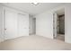 Bedroom with large closet and bathroom with tiled shower, and neutral walls and doors at 1846 Chestnut Ave, Erie, CO 80516