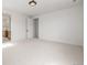A spacious bedroom with white carpet and trim and neutral walls and doors at 1846 Chestnut Ave, Erie, CO 80516
