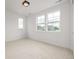 Bright bedroom featuring several windows and neutral walls and doors at 1846 Chestnut Ave, Erie, CO 80516
