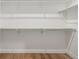 Walk in closet with white walls, custom shelving, and hardwood floors at 1846 Chestnut Ave, Erie, CO 80516
