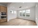 Bright dining area with hardwood floors, modern lighting, and large windows overlooking the backyard at 1846 Chestnut Ave, Erie, CO 80516
