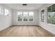 Bright dining room featuring hardwood floors and large windows offering lots of natural light at 1846 Chestnut Ave, Erie, CO 80516