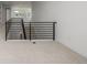 Hallway with plush carpet and black modern railings, showcasing the upper level of the home at 1846 Chestnut Ave, Erie, CO 80516