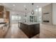 Open kitchen featuring a large island, stainless steel appliances, and a modern design at 1846 Chestnut Ave, Erie, CO 80516