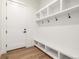 Well-organized mudroom with built-in shelving, hooks, and bench for convenient storage at 1846 Chestnut Ave, Erie, CO 80516