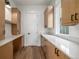 Walk-in pantry with custom shelving, white countertops, and hardwood floors at 1846 Chestnut Ave, Erie, CO 80516