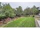 Well-maintained backyard featuring lush green lawn, mature trees, and beautiful landscaping at 3265 W 11Th Avenue Ct, Broomfield, CO 80020