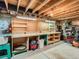 Unfinished basement space with a workbench area, featuring exposed beams and concrete floors at 3265 W 11Th Avenue Ct, Broomfield, CO 80020