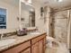 Updated bathroom with dual sinks, granite counters, and tiled walk-in shower at 3265 W 11Th Avenue Ct, Broomfield, CO 80020