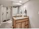 Bathroom featuring a granite-topped vanity and a glass-enclosed shower at 3265 W 11Th Avenue Ct, Broomfield, CO 80020