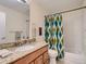 Bathroom with granite countertop, single sink, and shower-tub combination at 3265 W 11Th Avenue Ct, Broomfield, CO 80020