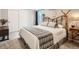 Cozy bedroom features a unique wooden bed frame, soft linens, and warm natural light at 3265 W 11Th Avenue Ct, Broomfield, CO 80020