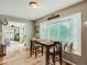 Bright breakfast nook with a view, hardwood floors, a table for two, and access to the porch at 3265 W 11Th Avenue Ct, Broomfield, CO 80020